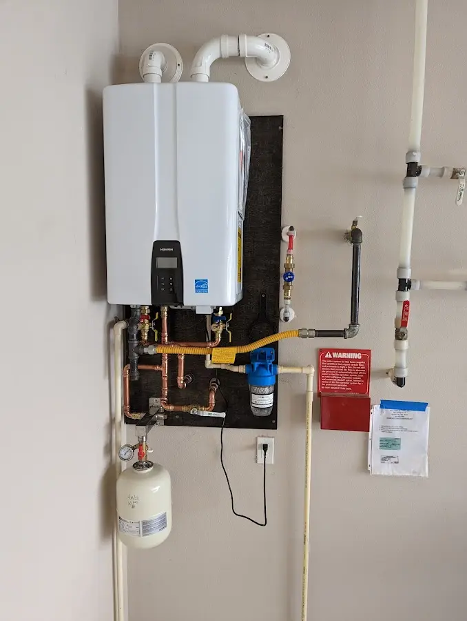 Professional plumber installing copper piping in a New Hanover home